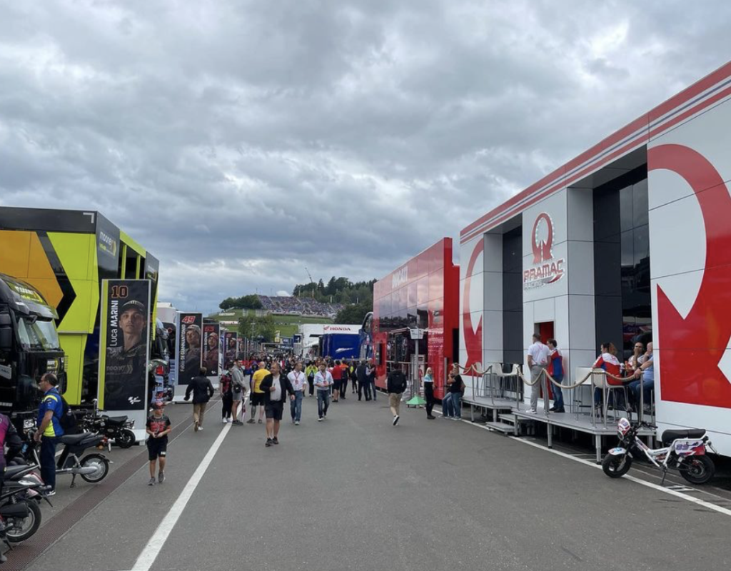 the view inside the MotoGP paddock, with trucks and hospitalities. 